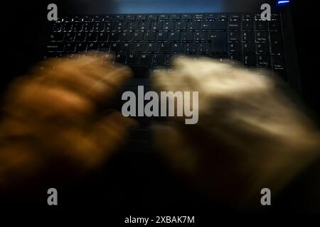 man hands typing on backlit pc keyboard Stock Photo