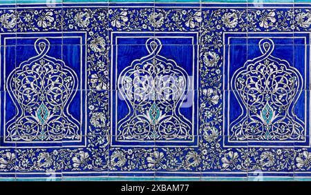 uzbek ceramic tile mosaic with traditional oriental Arabic Islamic pattern decorated with blue and white starry ornament Stock Photo
