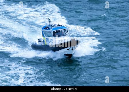 A UK Police Hunter cabin rigid inflatable boat or RIB on patrol in The Solent off the Hampshire coast near Portsmouth. Stock Photo