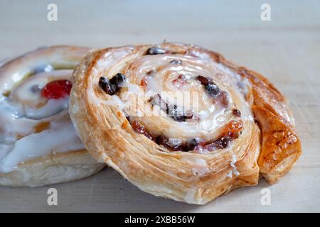 A large freshly baked sultana Danish Pastry cake topped with icing. The cake sometimes known simply as a Danish is made with sweet layered pastry Stock Photo