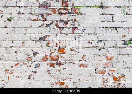 texture of a brick wall with peeling paint. background in the form of an old painted brick wall. painted brick wall Stock Photo
