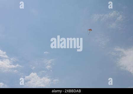 Colorful Kite Flying in Clear Sky Stock Photo