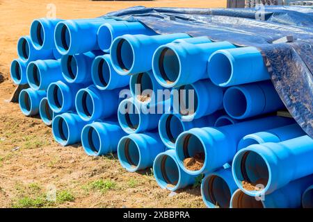 Blue PVC pipes are visible on construction site for laying pipe water system for new house Stock Photo