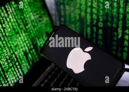 Krakow, Poland. 11th June, 2024. In this photo illustration, the Apple logo is seen displayed on a smartphone screen against a computer screens and its reflections displaying an illustration of stock market numbers as Apple announces plans to bring generative A.I. to more than a billion iPhone users worldwide. (Photo by Dominika Zarzycka/Sipa USA) Credit: Sipa USA/Alamy Live News Stock Photo
