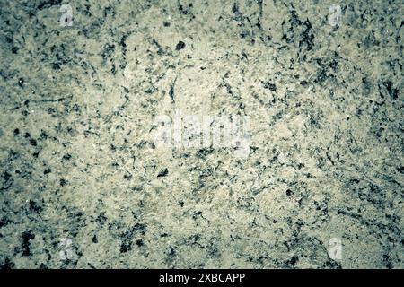 Rough granite texture with gray and black spots, displaying a natural rugged appearance, background image Stock Photo