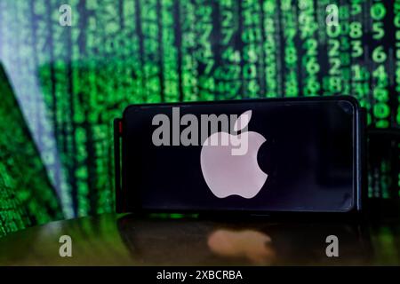 In this photo illustration, the Apple logo is seen displayed on a smartphone screen with a background of a computer screen displaying an illustration of stock market numbers. Apple announces plans to bring generative A.I. to more than a billion iPhone users worldwide. Stock Photo
