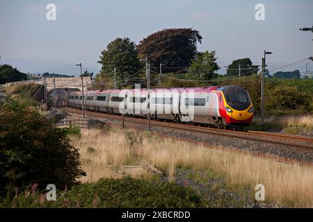 Virgin Trains class 390 Alstom Pendolino train  passing Elmsfiled, Cumbria on the west coast mainline Stock Photo