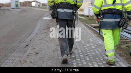 Construction Workers Walking on Site Stock Photo