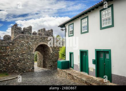 Bragança, Portugal - June 27, 2021: Porta do Sol from the wall of the Bragança castle in Portugal, seen from the inside, along with the old house. Stock Photo