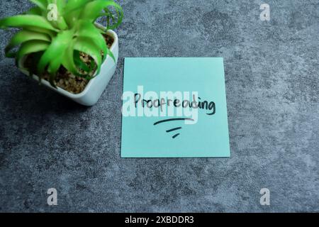 Concept of Proofreading write on sticky notes isolated on Wooden Table. Stock Photo