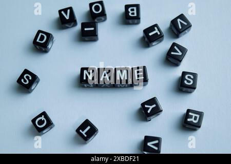 Concept of Name written on wooden blocks. Cross processed image on Wooden Background Stock Photo