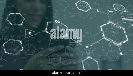 Image of chemical formulas over girl using smartphone Stock Photo