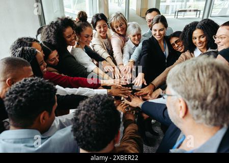 Diverse team demonstrating teamwork and inclusion at a conference, focusing on unity and collaboration. Stock Photo