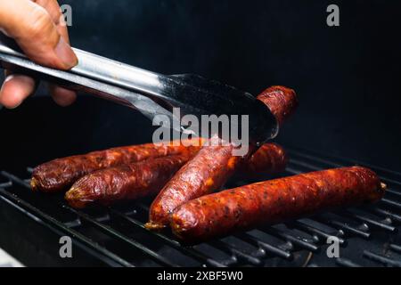 sausage with edible collagen casing is being cooked using the smoking method Stock Photo