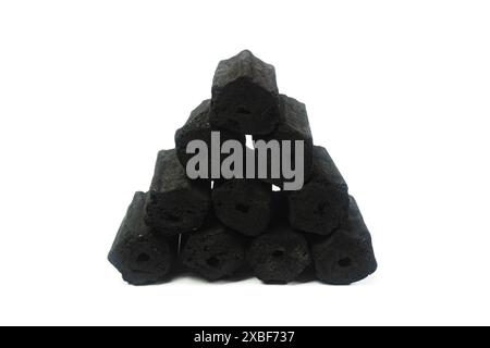 pile of hexagonal charcoal briquettes isolated on a white background Stock Photo