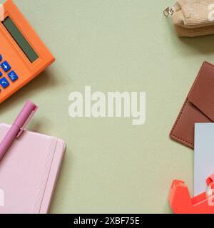 Various office and school supply. calculator, pen, notebook, pencil case, card wallet, memo pad, tape dispenser on khaki desk background. top view Stock Photo