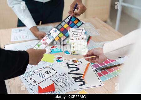 Creative Team collaboration on UX UI Design Concepts with Wireframes and Color Palettes for Mobile Application Development Stock Photo