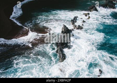 An aerial view from the hiking trail of the blue waters crashing on the rocks in Maui, Hawaii Stock Photo