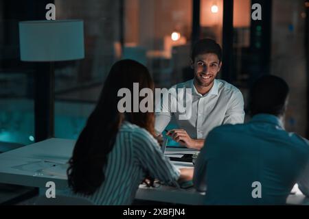 Paperwork, portrait and man in meeting, night and smile for teamwork, deadline and project for website. Business, assignment and admin assistant Stock Photo
