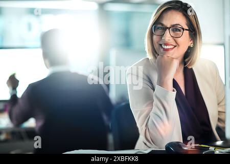 Thinking, woman and portrait on computer in office, web designer, research and planning creative project. Smile, female person, developer and Stock Photo