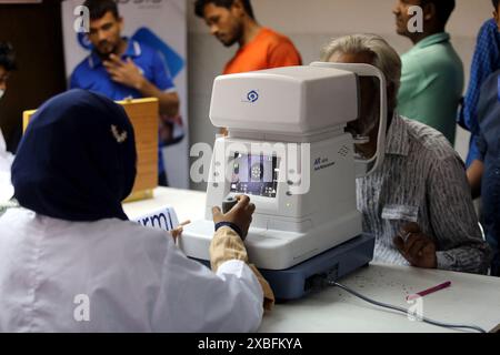 Dhaka, Bangladesh. 11th June, 2024. An ophthalmologist examines a patient's eyes during the Free Medical Eye Camp at Urmi Garment Factory For Garments Workers On June 11, 2024, Dhaka, Bangladesh. Photo by Habibur Rahman/ABACAPRESS.COM Credit: Abaca Press/Alamy Live News Stock Photo