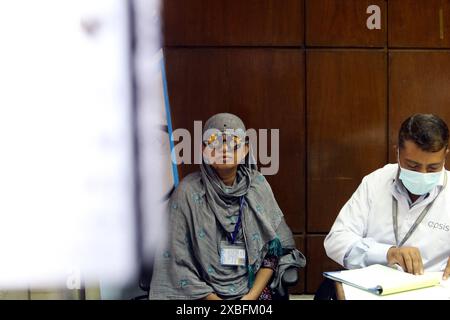 Dhaka, Bangladesh. 11th June, 2024. An ophthalmologist examines a patient's eyes during the Free Medical Eye Camp at Urmi Garment Factory For Garments Workers On June 11, 2024, Dhaka, Bangladesh. Photo by Habibur Rahman/ABACAPRESS.COM Credit: Abaca Press/Alamy Live News Stock Photo