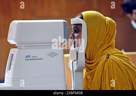 Dhaka, Bangladesh. 11th June, 2024. An ophthalmologist examines a patient's eyes during the Free Medical Eye Camp at Urmi Garment Factory For Garments Workers On June 11, 2024, Dhaka, Bangladesh. Photo by Habibur Rahman/ABACAPRESS.COM Credit: Abaca Press/Alamy Live News Stock Photo