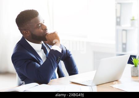 Thoughtful businessman making business solution at workplace Stock Photo