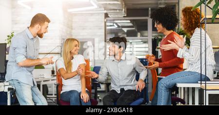 Group of People Employees Sitting Around Each Other in Office Stock Photo