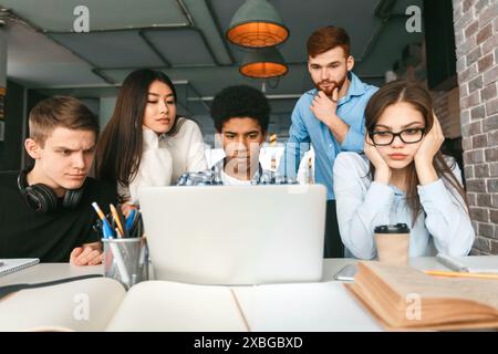 Group of Young Adults Engaged in Collaborative Work Stock Photo