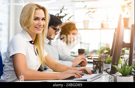Open Concept Office with Young Employees Collaborating Stock Photo