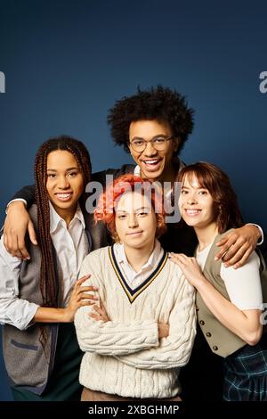 Multicultural friends, stand together in stylish attire on a dark blue background. Stock Photo