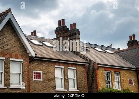 LONDON- Large British houses in with rooms built in to the attic spaces showing roof windows Stock Photo