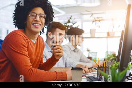 Cheerful african american guy smiling at camera at coworking Stock Photo