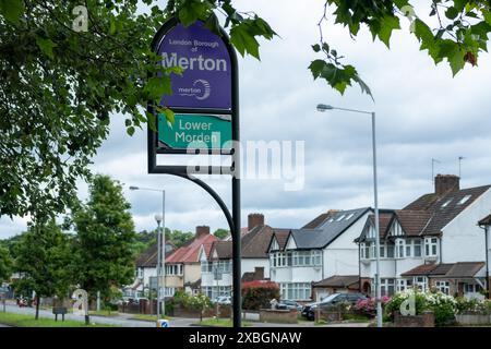 LONDON- JUNE 10, 2024: Boundary sign for the borough of Merton with residential houses in lower Morden, south west London Stock Photo