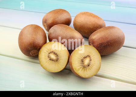 sliced golden kiwi on wood background Stock Photo