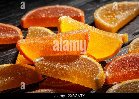 citrus candy on black wood background Stock Photo