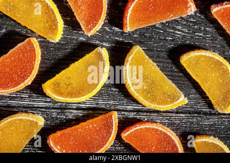 citrus candy on black wood background top view Stock Photo