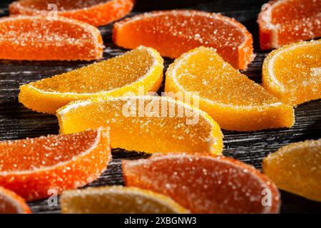 citrus candy on black wood background Stock Photo