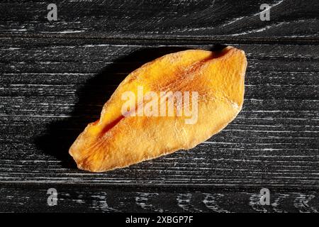 dry mango on black wood background top view Stock Photo