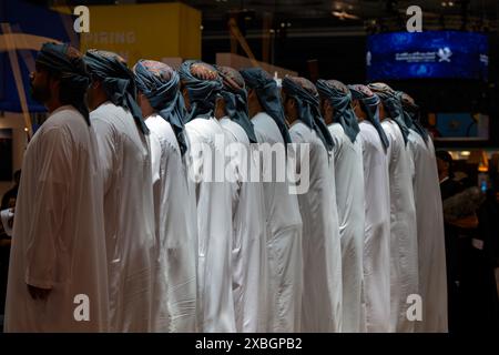 Omani men lined up for traditional singing and dancing in DECC Qatar Stock Photo