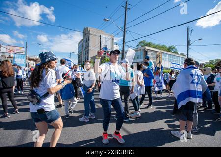 People dance in the street during UJA (United Jewish Appeal Federation of Greater Toronto) annual Walk For Israel march. Stock Photo