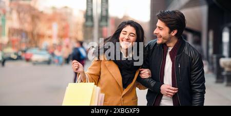 Excited couple doing shopping on weekend together Stock Photo