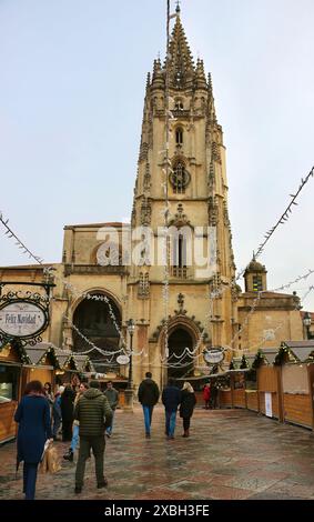 People at the Christmas market in front of the Cathedral of the Holy Saviour on a wet January day Oviedo Asturias Spain Stock Photo