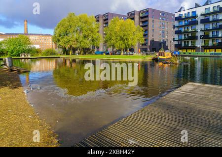 Manchester UK - October 08, 2022: Scene of the Cottonfield Wharf, with canals and boats, local businesses, locals, and visitors, in New Islington Mari Stock Photo