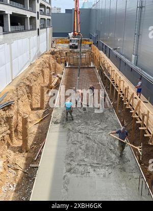 Construction workers pouring foundation. Construction and crew work. June 12, 2024 Stock Photo