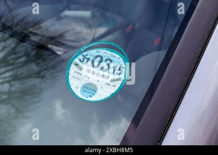 A UK tax disc displayed inside the windscreen of a domestic car. Since October 2014 the tax disc is no longer required. Stock Photo