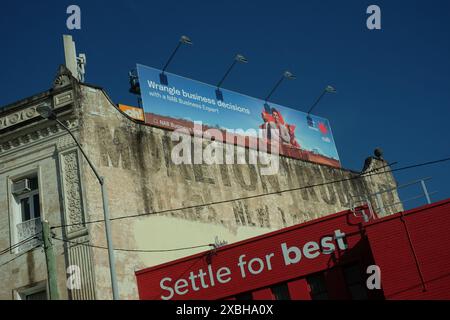 Morton Rubber, a well known old advertising sign on the wall of a Victorian era building in Woolloongabba & contemporary billboard for a bank above. Stock Photo