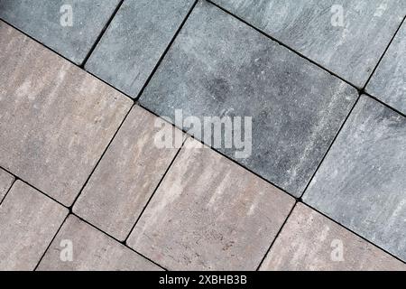 Multicolored paving slabs for road paving by mosaic on shop window. Construction Stock Photo