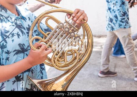 close-up of a horn which is played by a young man on the streets of a town Stock Photo